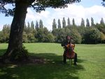 Doug performs in the shade of a tree in the park